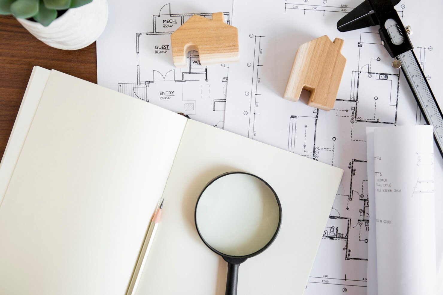 notebook-near-drafts-house-figures_23-2147831960